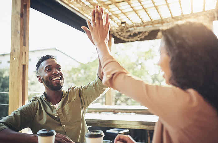 A man and woman giving each other a high five